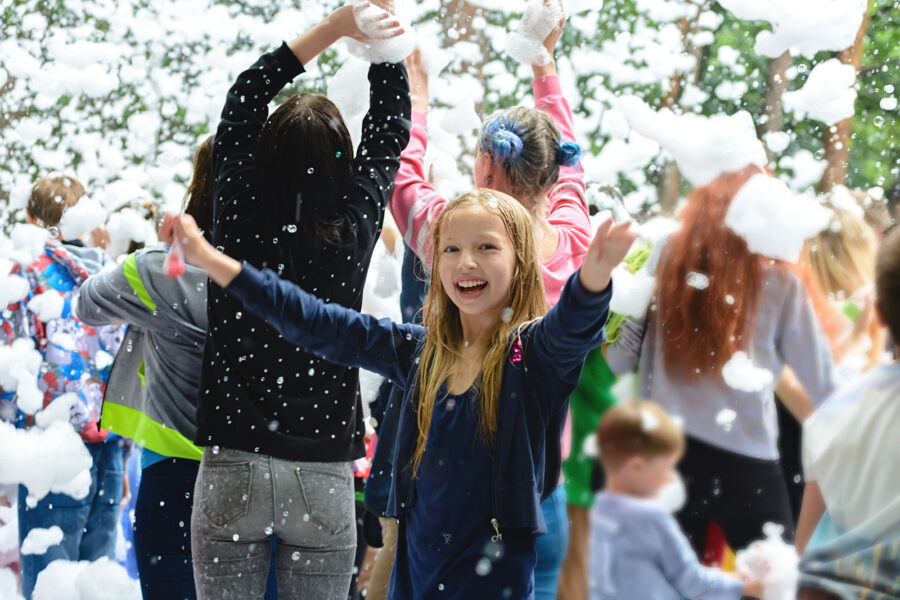Children playing in foam at park event