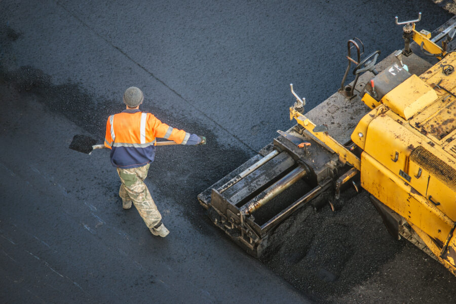 Workers lay new asphalt