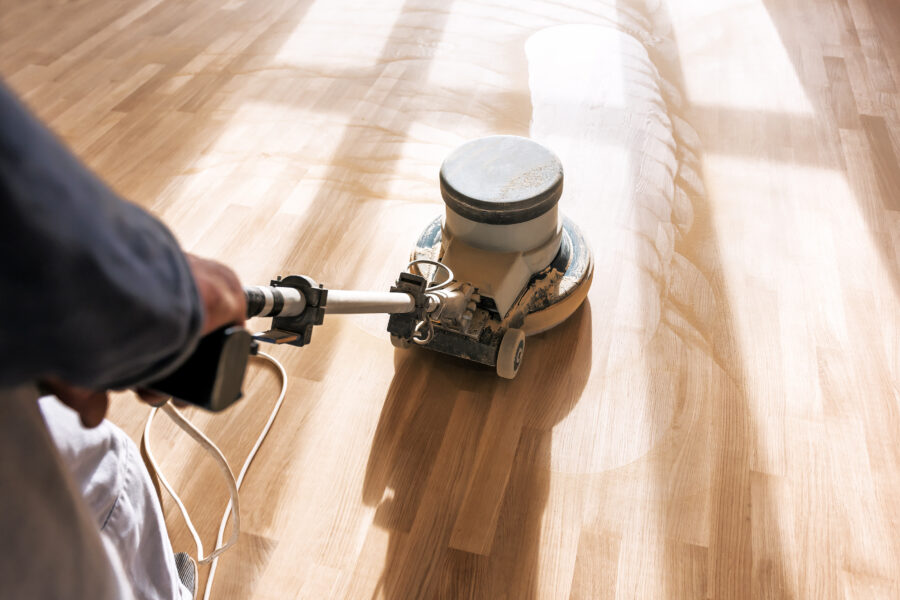 Technician polishing wood floor